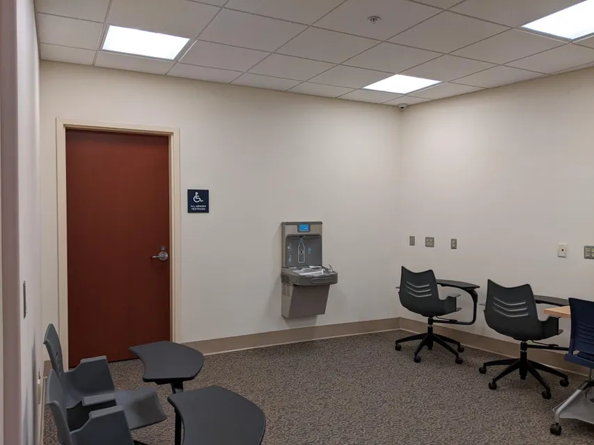 In a corner of the OAS Testing Center is an all gender restroom next to a water fountain and bottle filling station. 